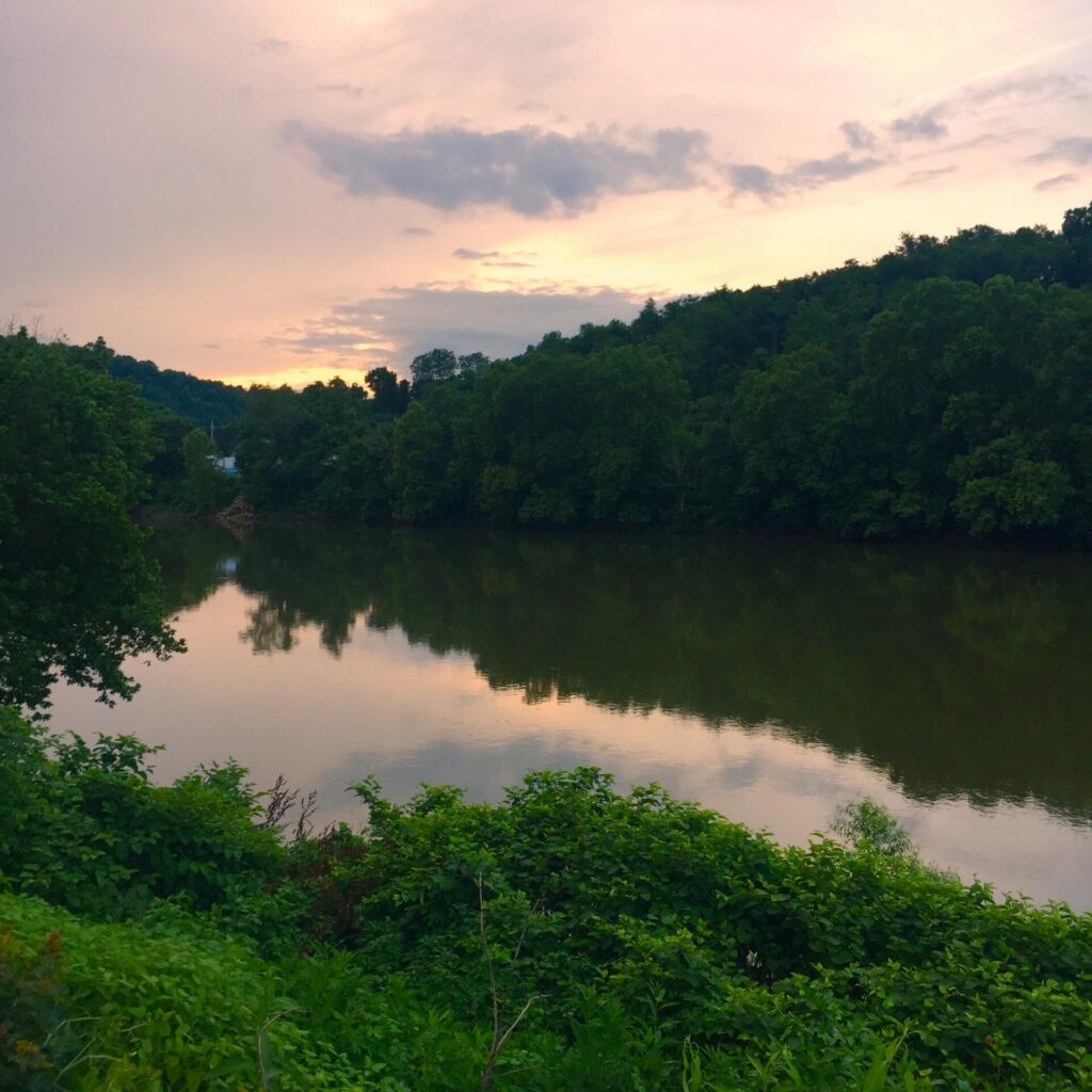 The sun sets behind the Youghiogheny River as seen from Smithdale, PA
